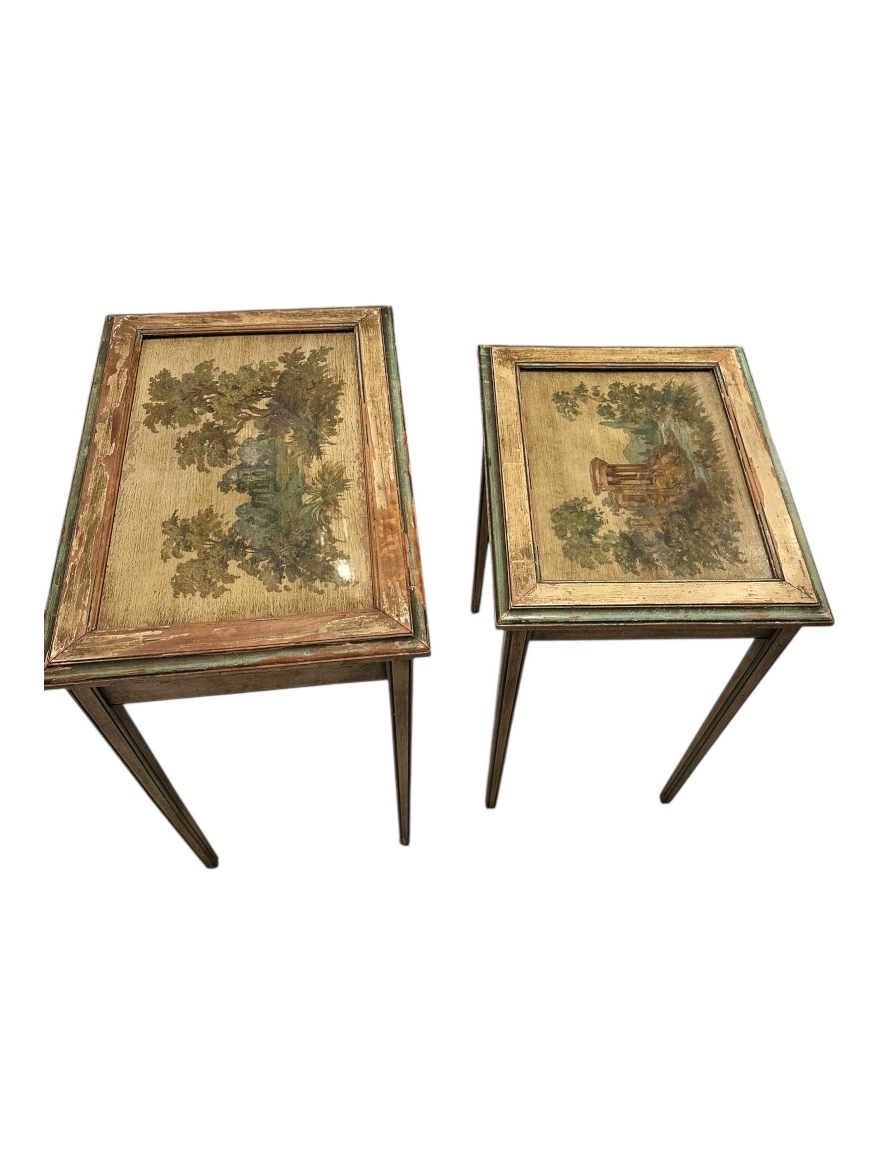 Pair of Venetian-style nesting tables side by side, showing painted tops and worn frames.
