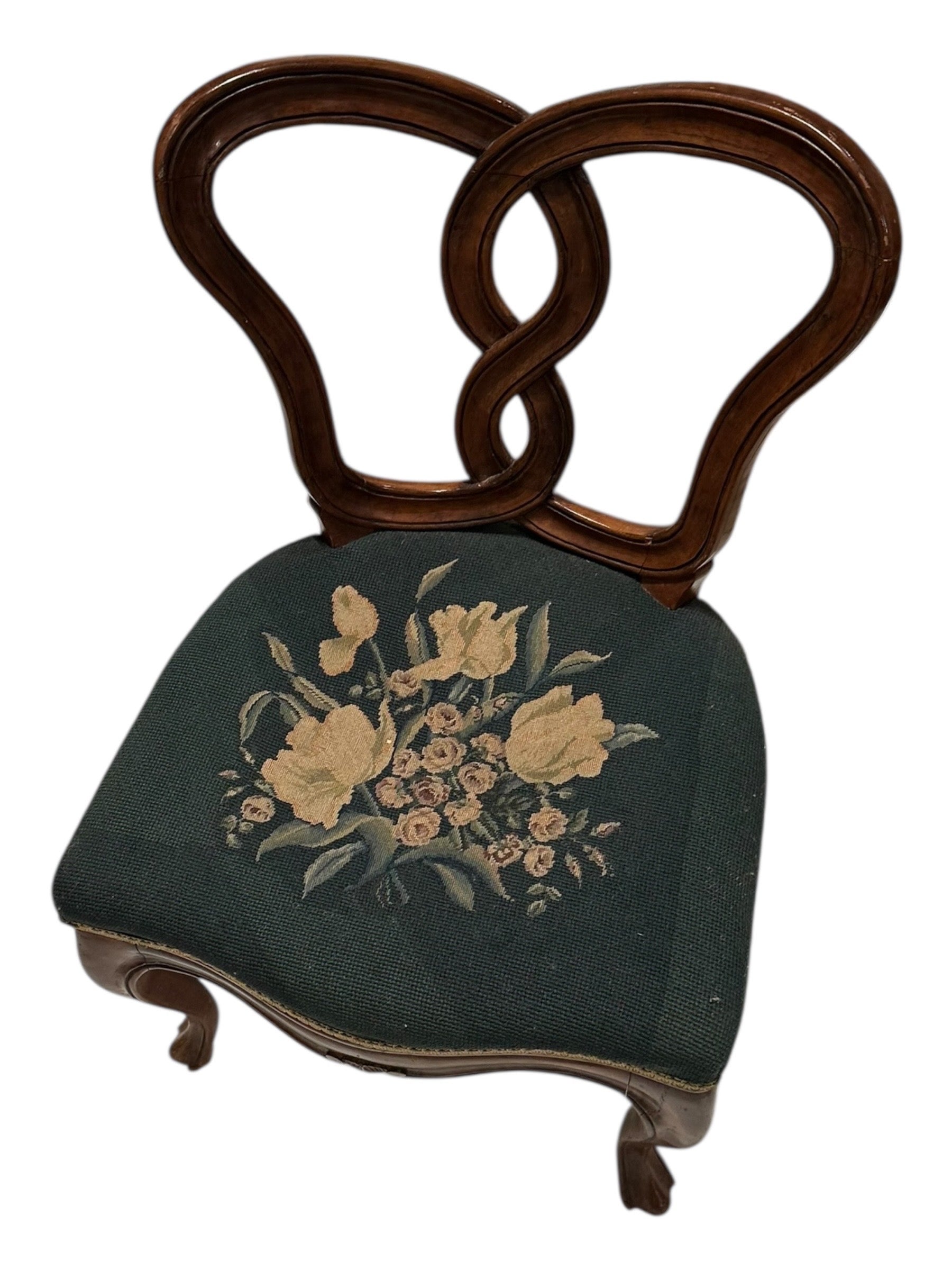 Walnut pretzel-back boudoir chair with floral needlepoint seat, angled front view