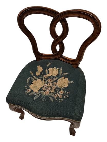 Walnut pretzel-back boudoir chair with floral needlepoint seat, angled front view