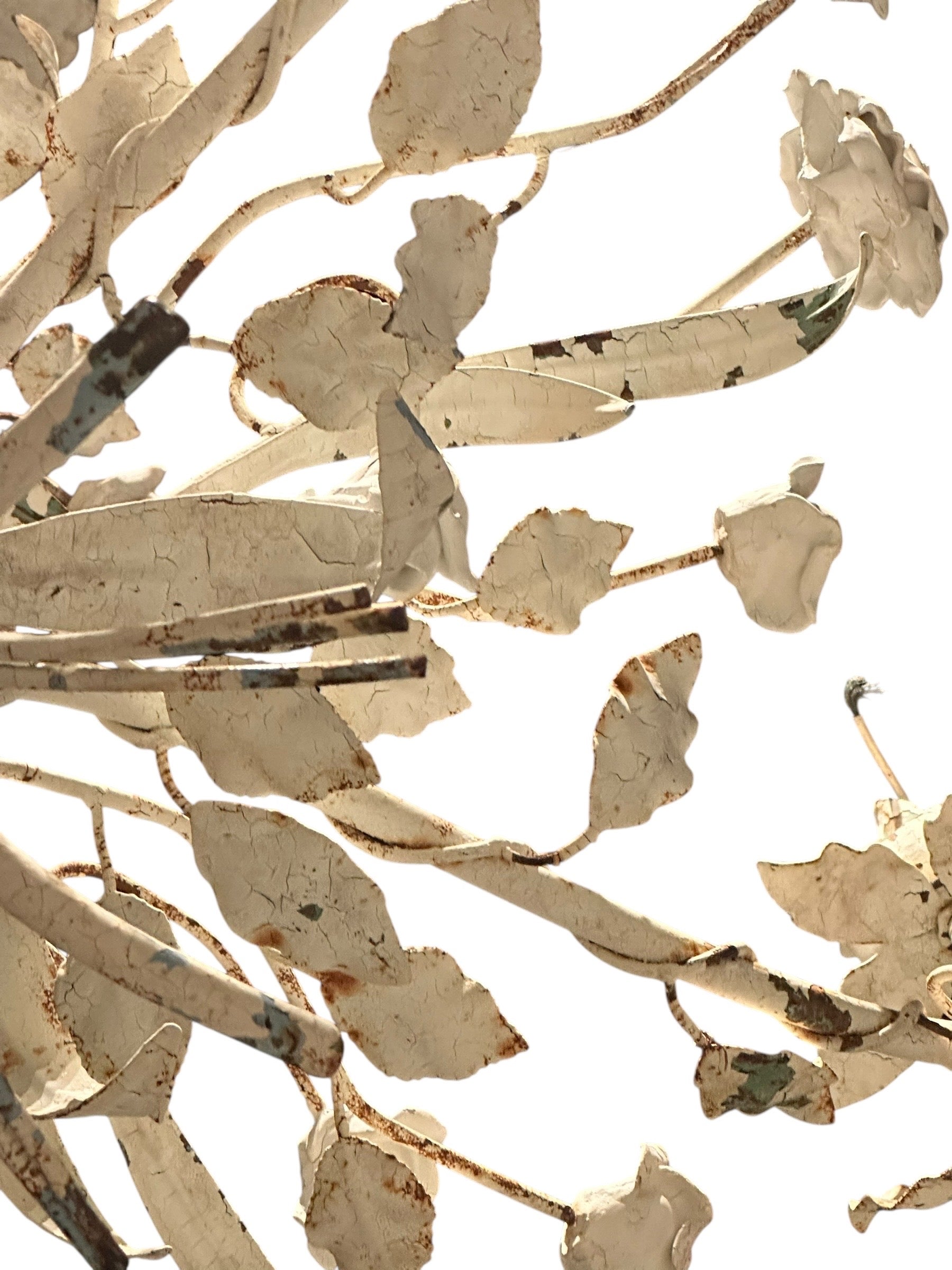 Worn cream floral metal chandelier, close-up of leaf and rose foliage detail