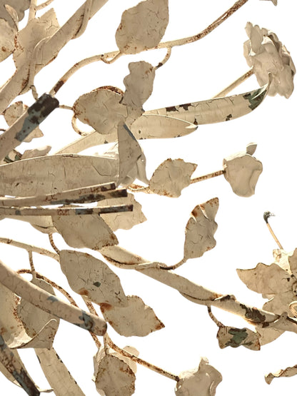 Worn cream floral metal chandelier, close-up of leaf and rose foliage detail