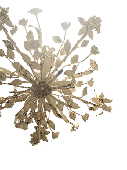 Cream painted floral chandelier viewed from below showing radiating leaf arms