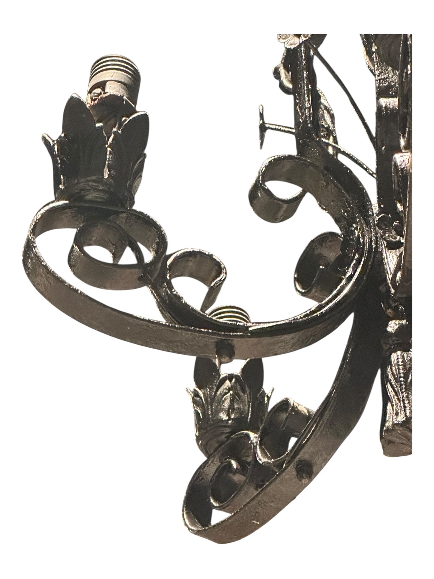 Underside detail of black wrought iron chandelier showing central tassel finial