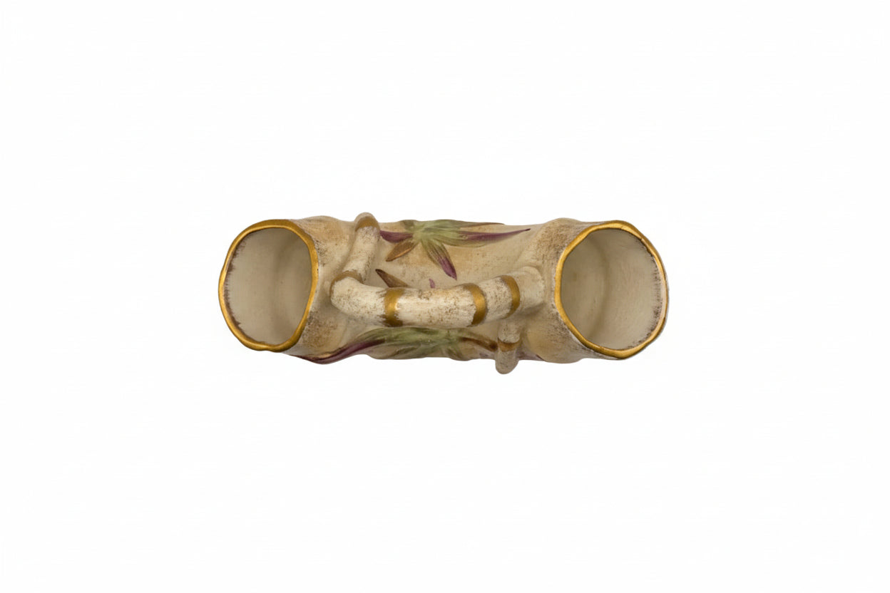 Top-down view of the double-ended bamboo vase showing both open gilt-rimmed openings