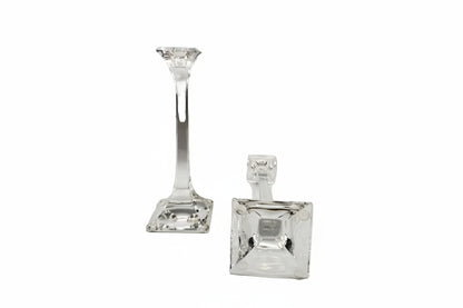 Tiffany & Co. crystal candlestick upright beside a second laid down to show the square base