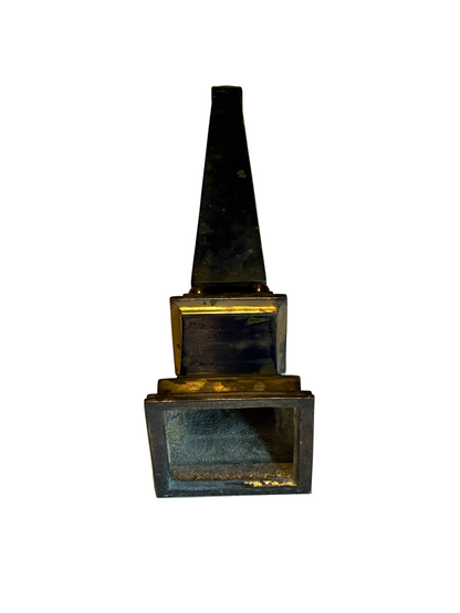 Rear view of blue faux-painted brass obelisk showing darker patina and open stepped base