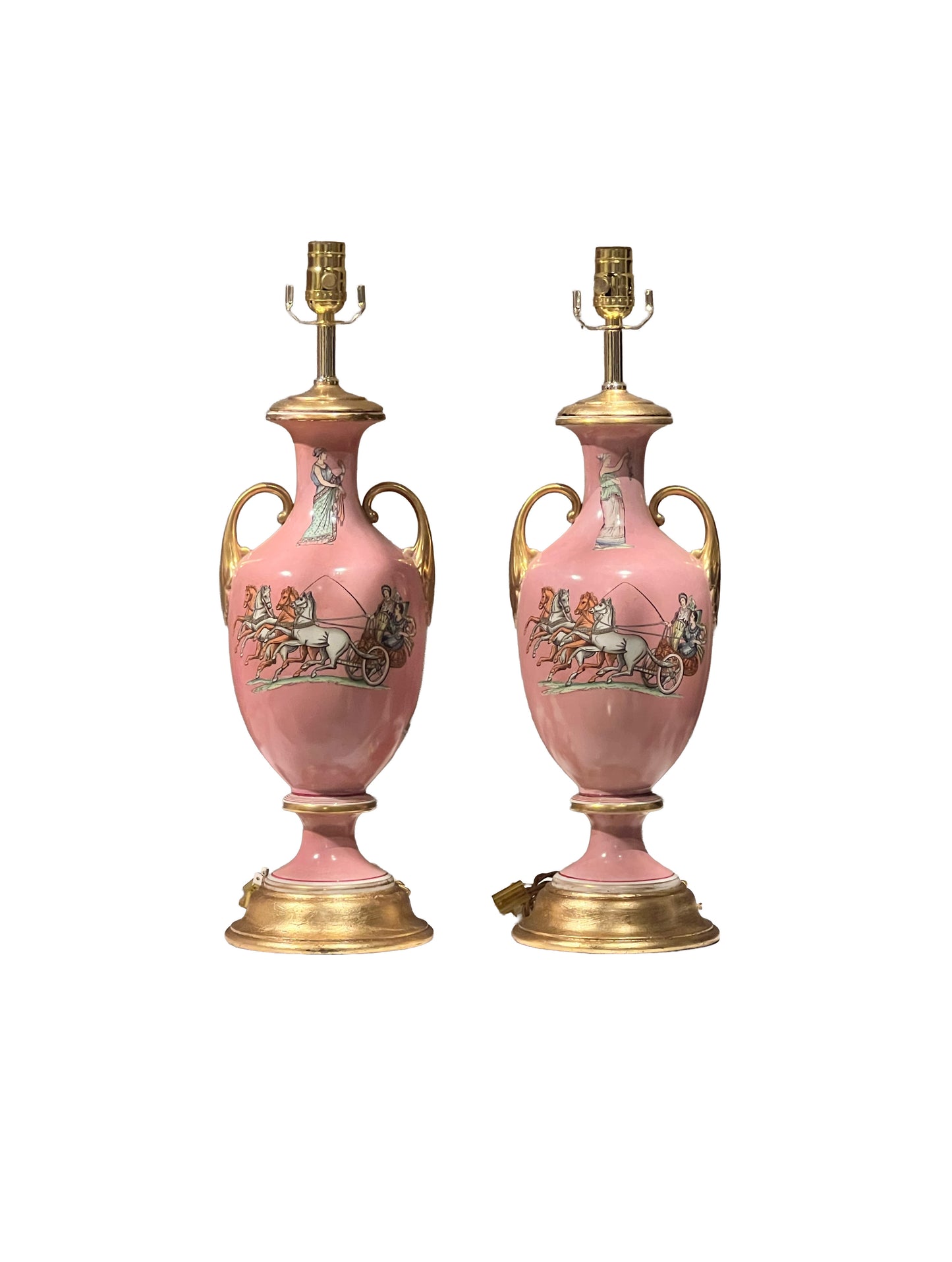 Pair of pink neoclassical urn lamps with gold handles and chariot scenes on a white background