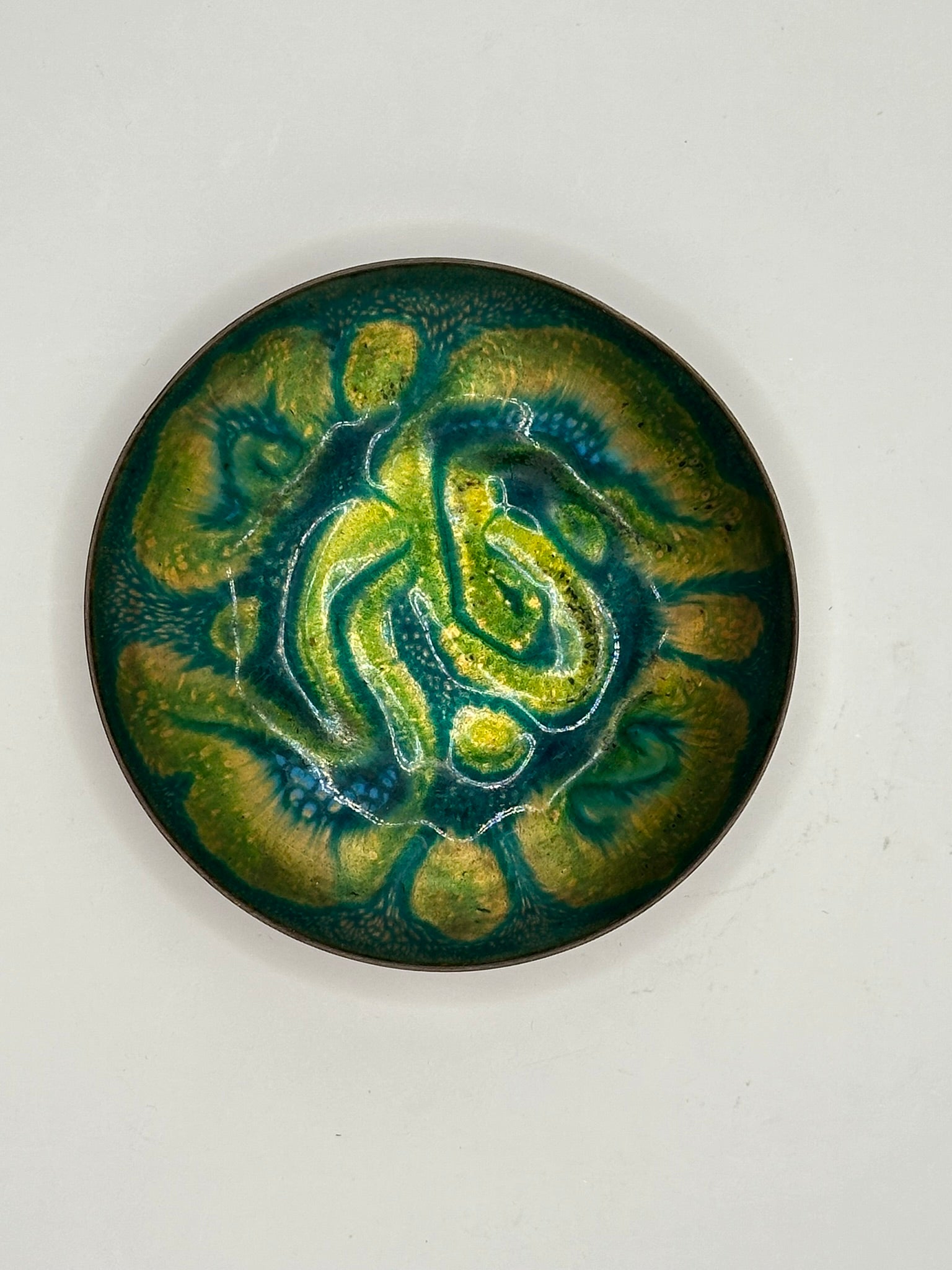 Doris Hall small green enamel dish, overhead view of green-yellow swirl with blue accents