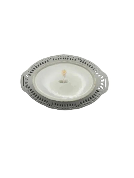 Overhead angled view of the oval pierced-lattice porcelain bowl with painted floral center