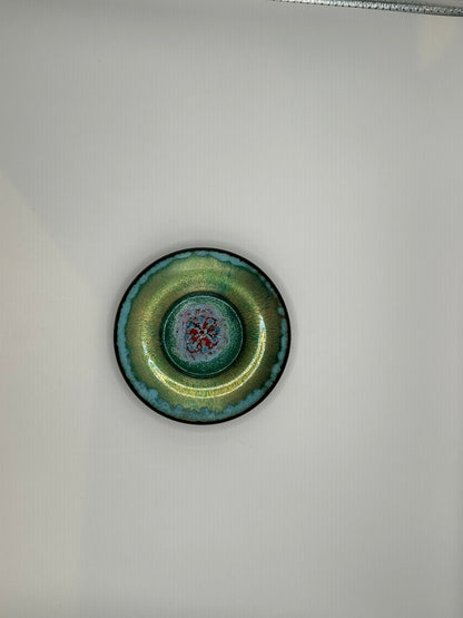 Doris Hall petite green enamel dish, top view with teal rim and red floral starburst center