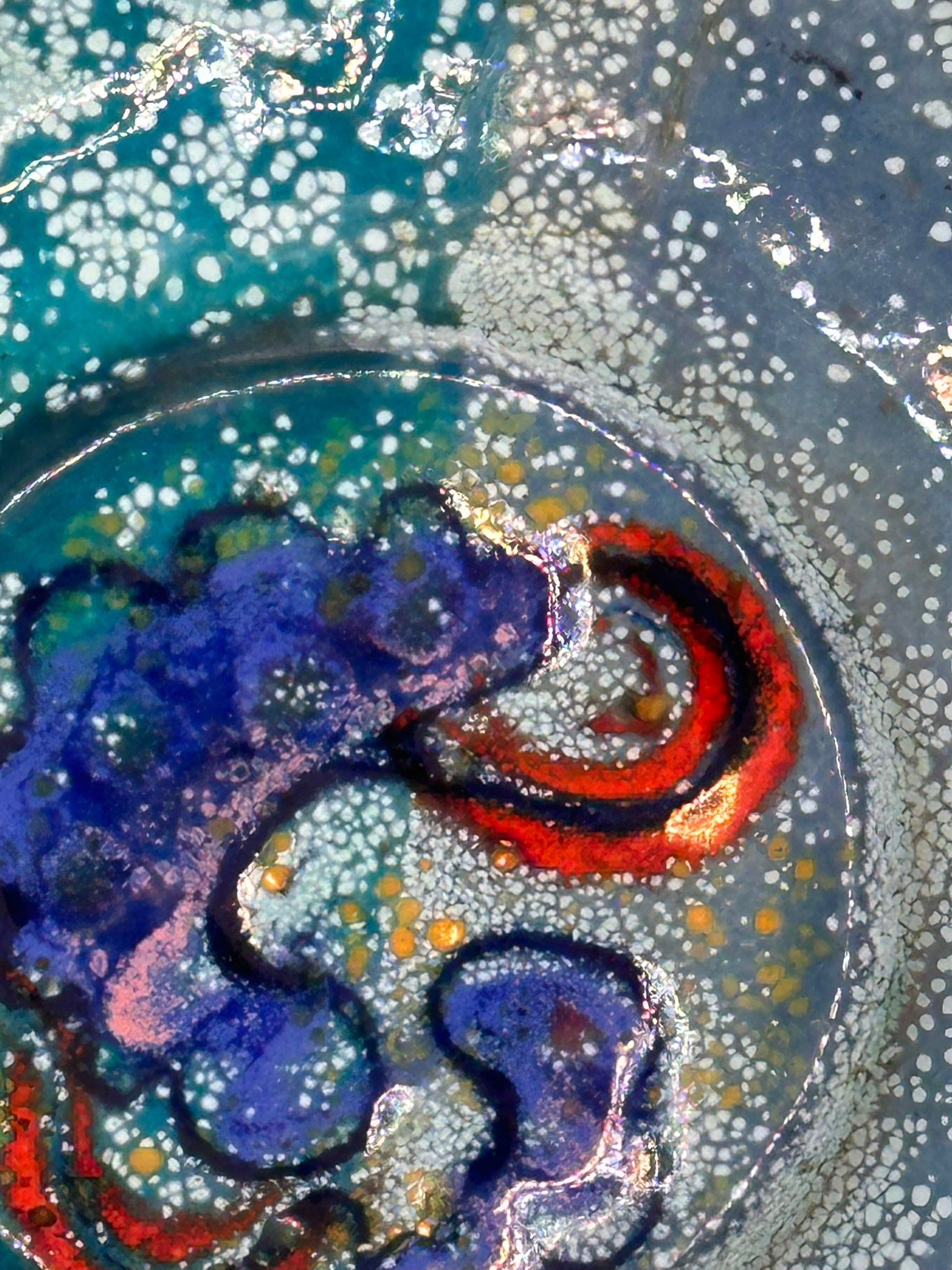 Close-up of Doris Hall dish center, cobalt-blue swirl and red arc detail in speckled enamel glaze
