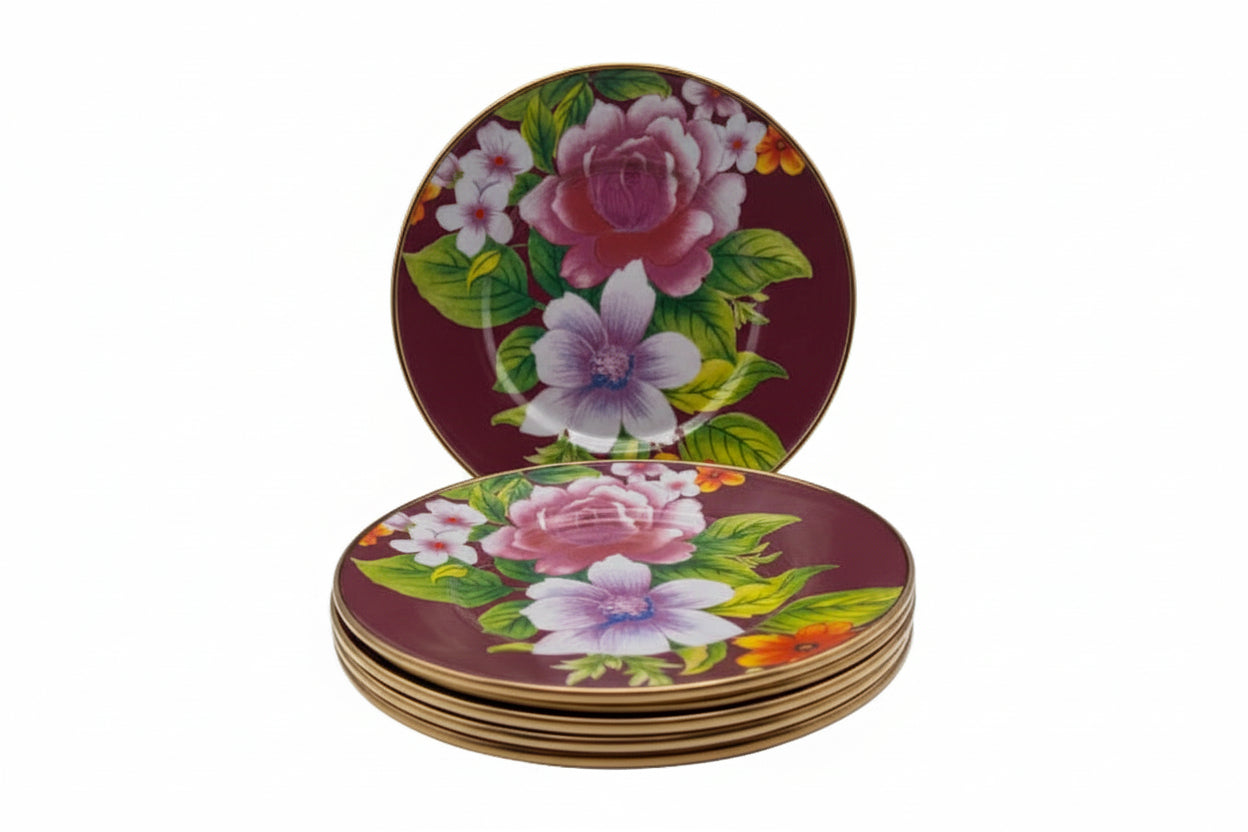 Stack of six MacKenzie-Childs Flower Market salad plates, burgundy ground with floral bouquet and gold rim