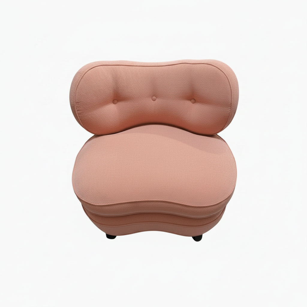 Antique pink coral boudoir chair, kidney-shaped tufted back and rounded seat, studio front view