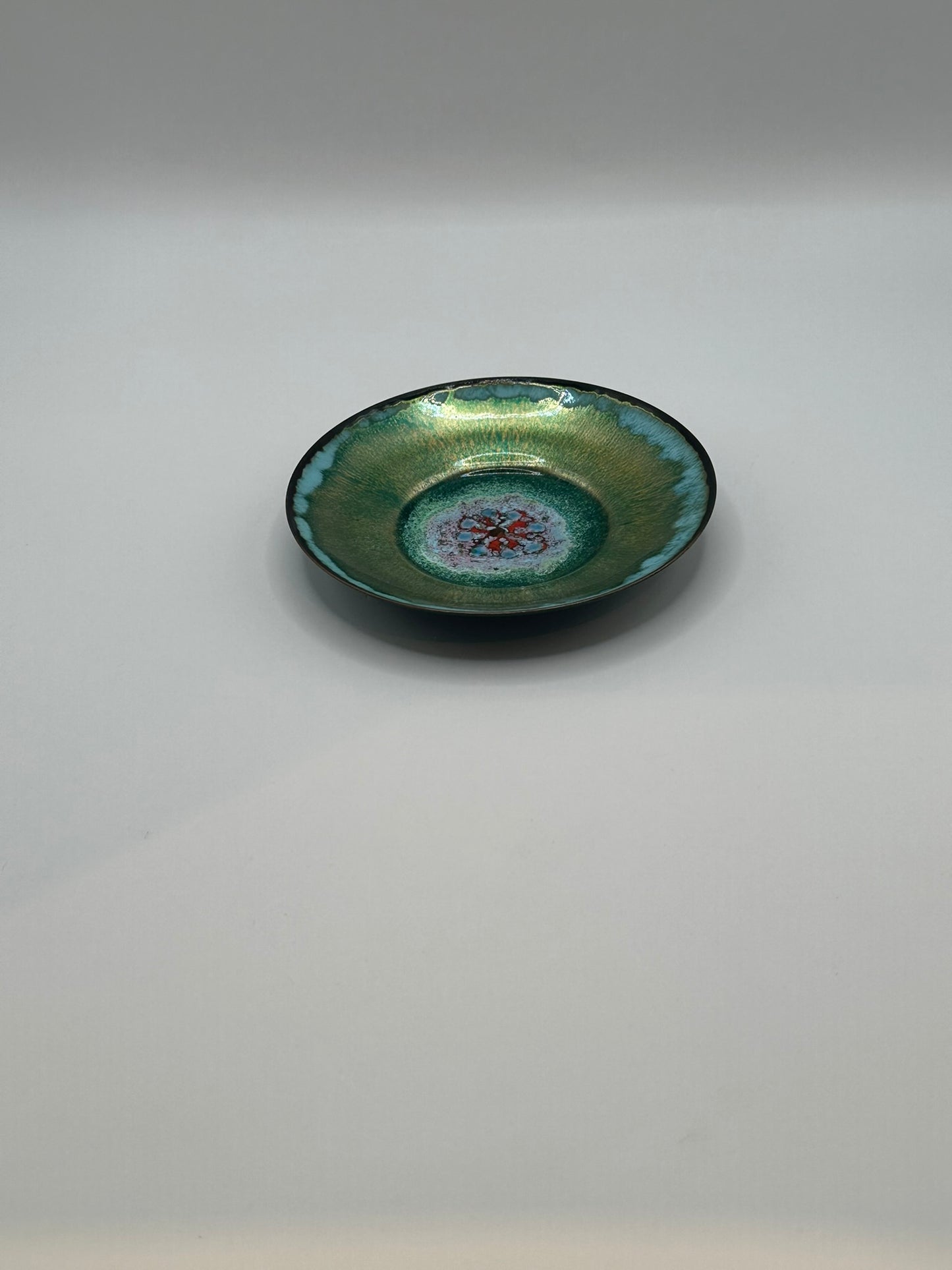 Doris Hall petite green enamel dish, angled profile showing teal rim and red floral center