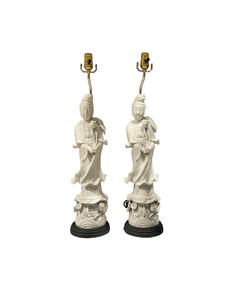 Pair of white Asian-inspired figural table lamps shown front-facing on black wood bases
