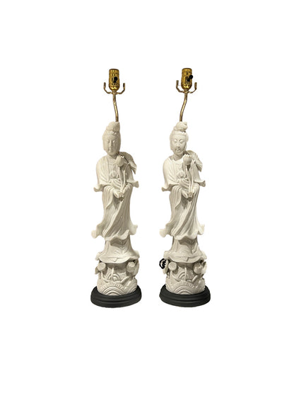 Pair of white Asian-inspired figural table lamps shown front-facing on black wood bases