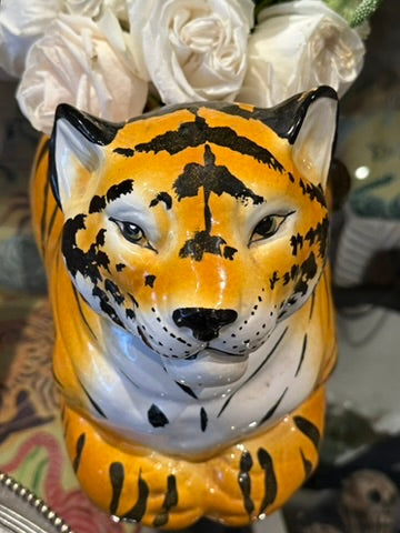 Vintage ceramic tiger planter styled with white roses, front view of the striped tiger bust.