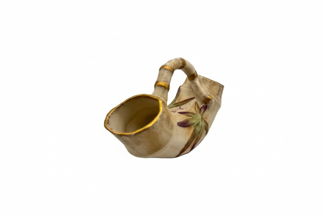 Angled view of the ceramic bamboo double vase showing one open trumpet end and arched handle