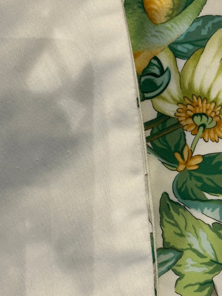 Brunschwig & Fils Anima tablecloth edge detail showing passionflower and green foliage near the border