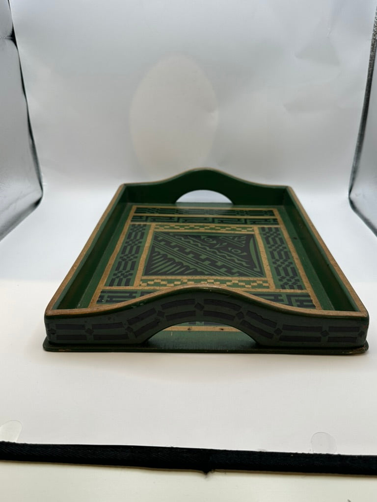 Side profile of green wood tray showing arched cutout handle and patterned apron