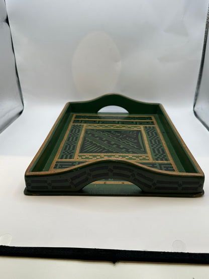 Side profile of green wood tray showing arched cutout handle and patterned apron