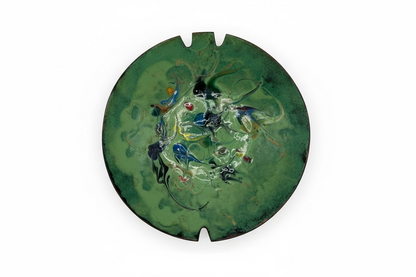 Vintage MCM enamel-over-copper ashtray, top view, green with multicolor abstract swirls and two cigarette rests