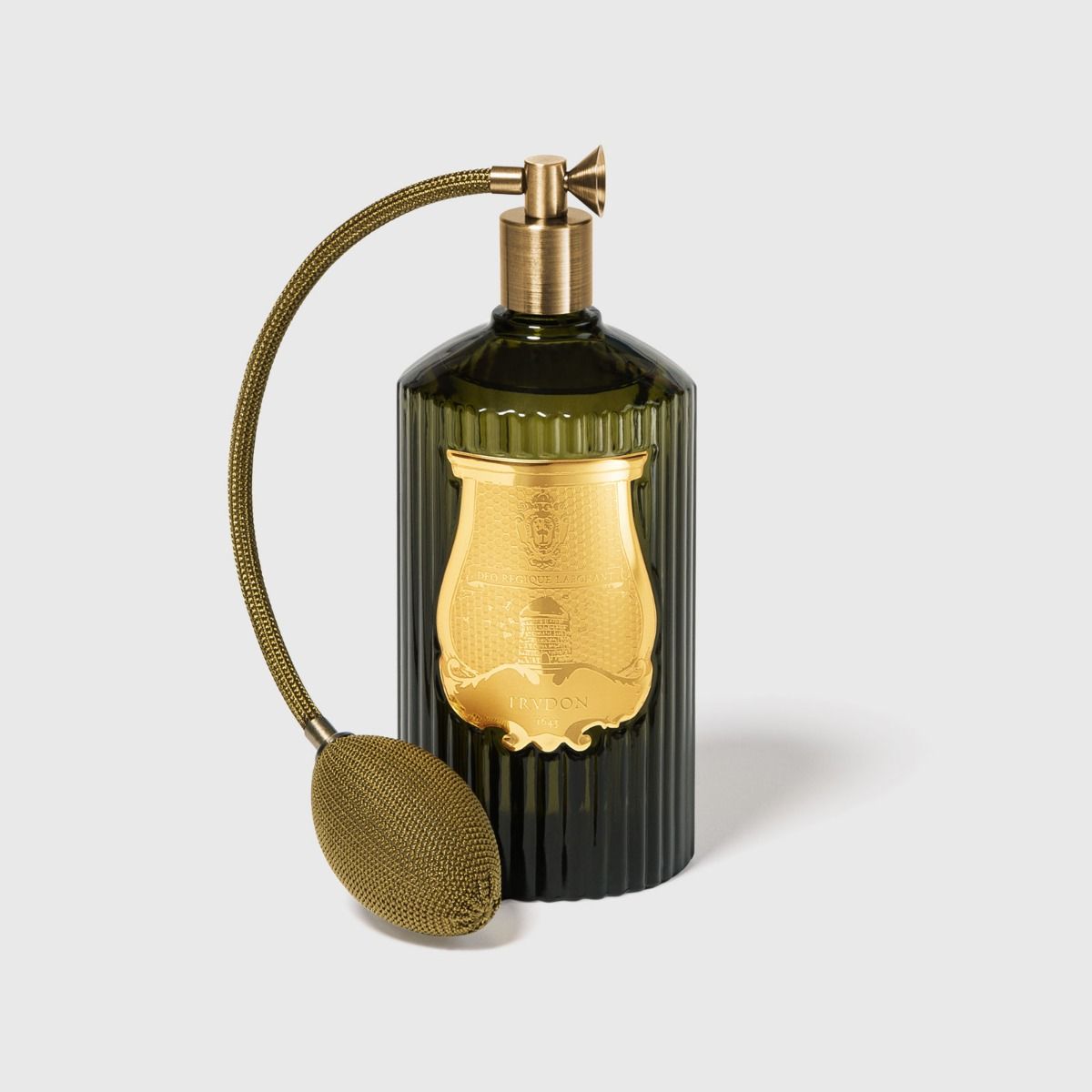 Trudon Abd El Kader room spray, fluted dark green glass bottle with gold label and brass bulb atomizer.