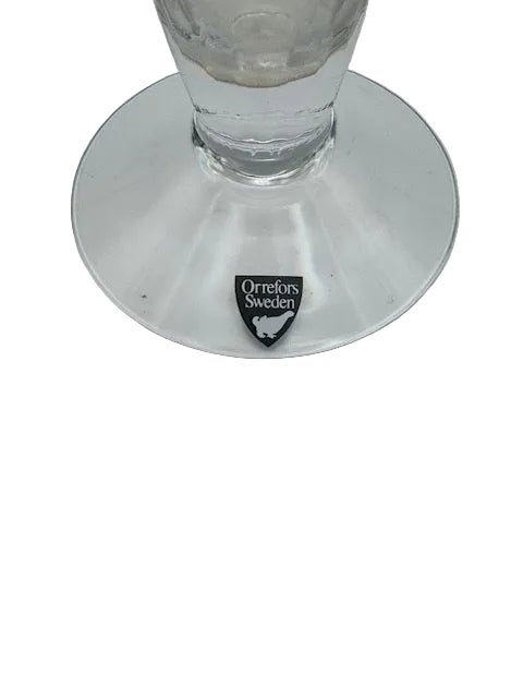 Close-up of the bud vase clear disc foot with black Orrefors Sweden maker's label