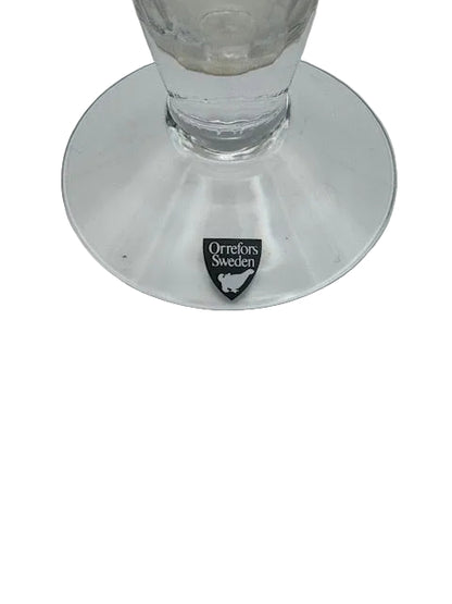 Close-up of the bud vase clear disc foot with black Orrefors Sweden maker's label