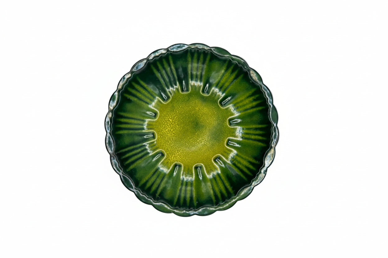 Vintage MCM enamel-over-copper dish, top view, radiating green stripes with yellow center, scalloped rim