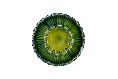 Vintage MCM enamel-over-copper dish, top view, radiating green stripes with yellow center, scalloped rim
