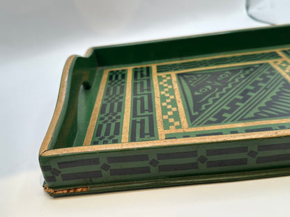 Angled close view of green tray corner showing geometric border and chipped gilt trim
