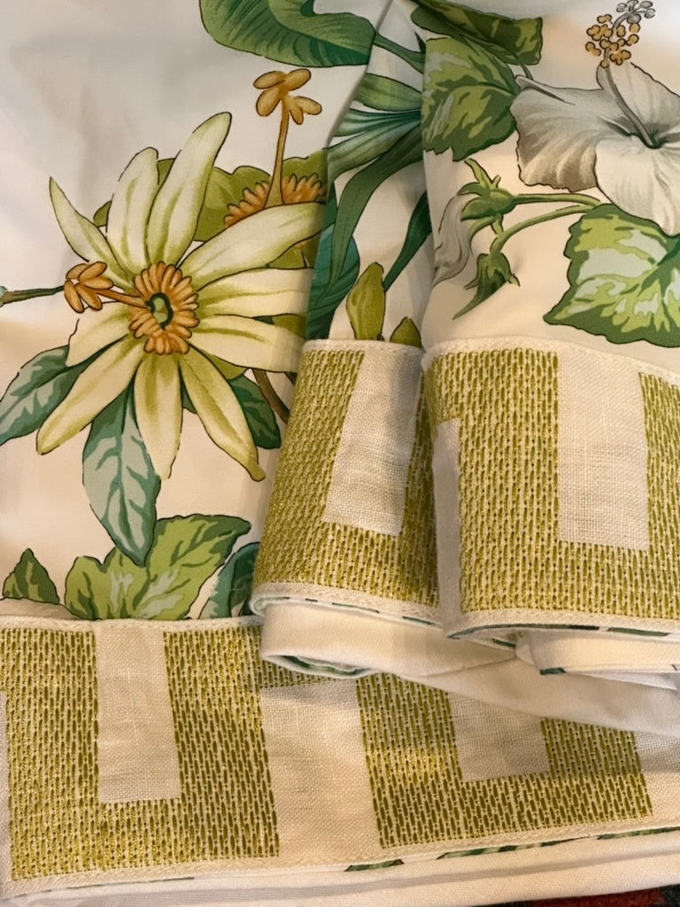 Brunschwig & Fils Anima tablecloth folded to show passionflower, hibiscus and chartreuse block trim