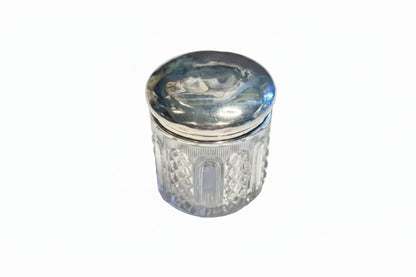 Vintage cut glass and sterling silver vanity jar, closed with domed silver lid and diamond-cut glass body.