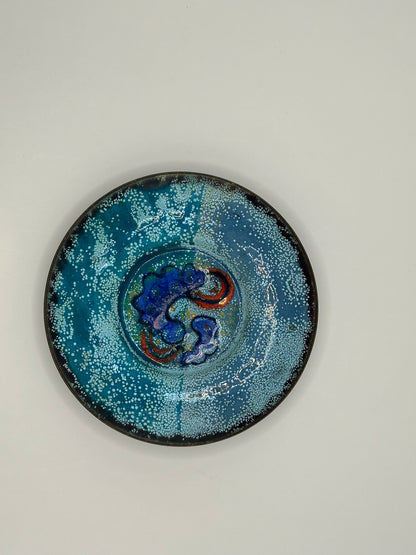 Doris Hall turquoise enamel dish, overhead view of blue and red abstract glaze center