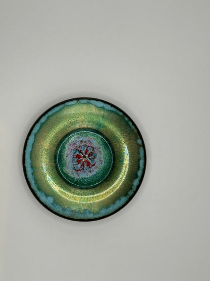 Doris Hall petite green enamel-on-copper dish, overhead view of red floral starburst center