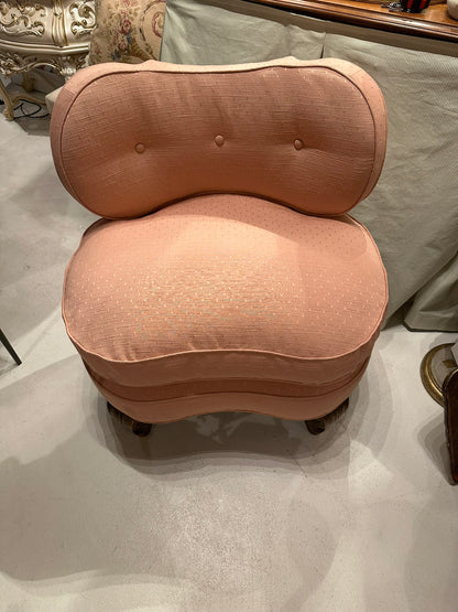 Antique pink coral boudoir chair, frontal view of buttoned back and plump seat cushion