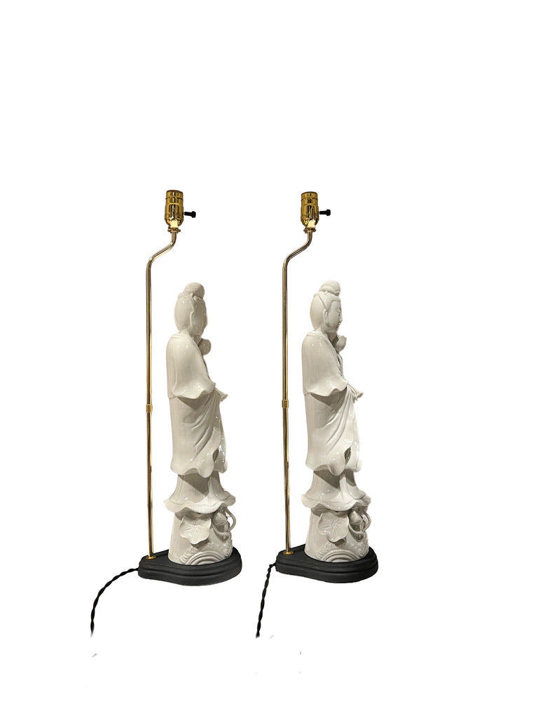 Pair of white figural table lamps in profile, brass harps and black oval bases
