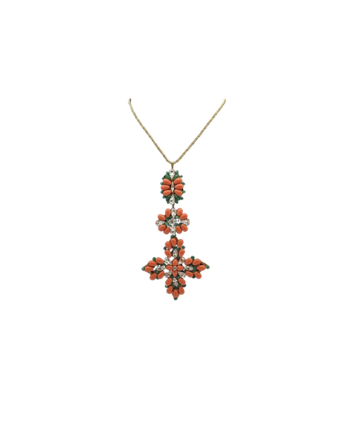 Triple coral cross necklace with orange coral and clear crystal flowers on a gold chain, on white