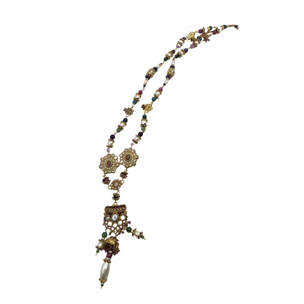 Mughal Indian beaded necklace laid diagonally, showing full strand of mixed gemstone beads and pendant