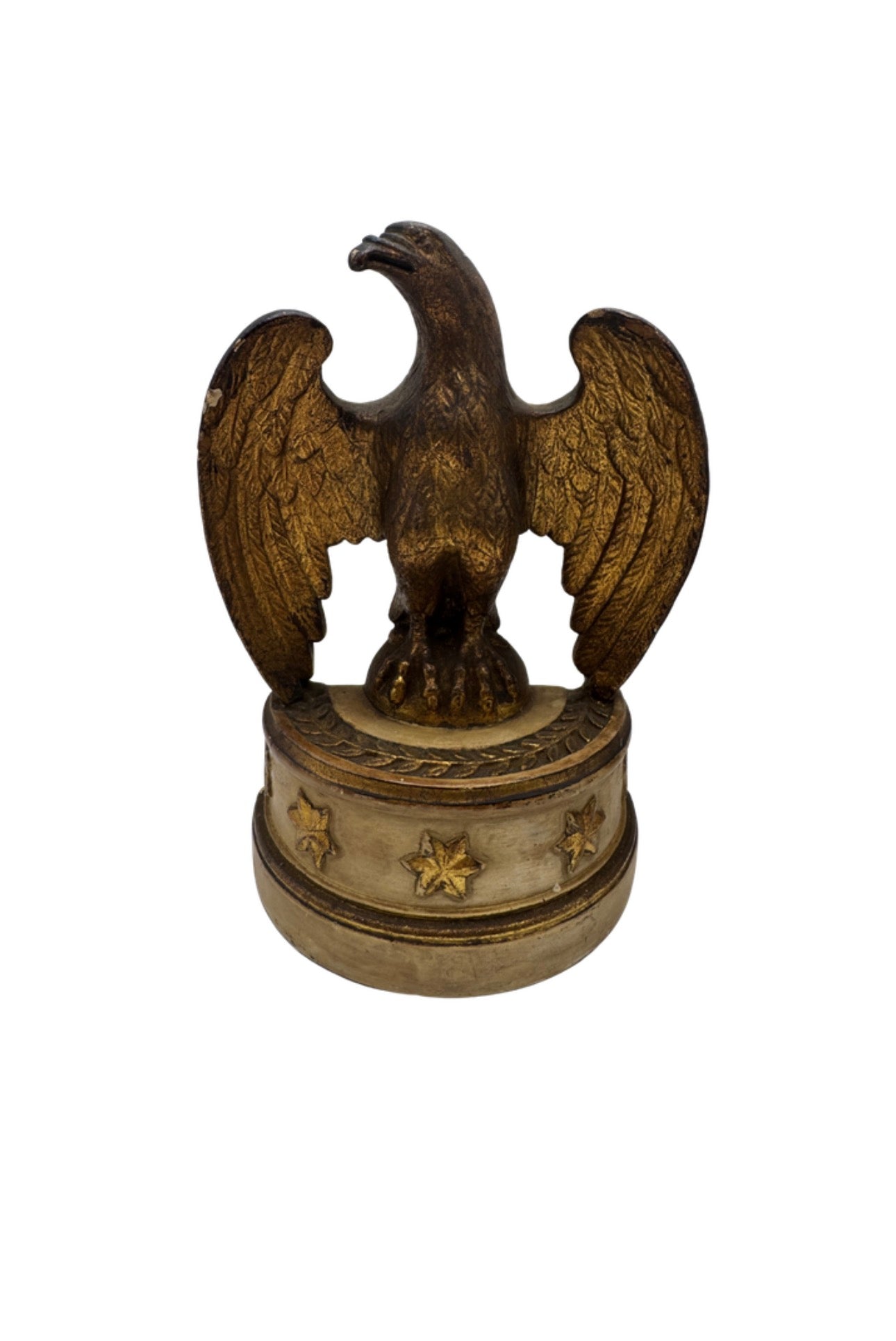 Single Borghese gilt eagle with raised wings on a cream pedestal base decorated with gold stars, front view