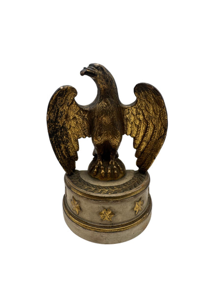 Single Borghese gilt eagle bookend, front view, wings spread on a star-decorated cream and gold round base