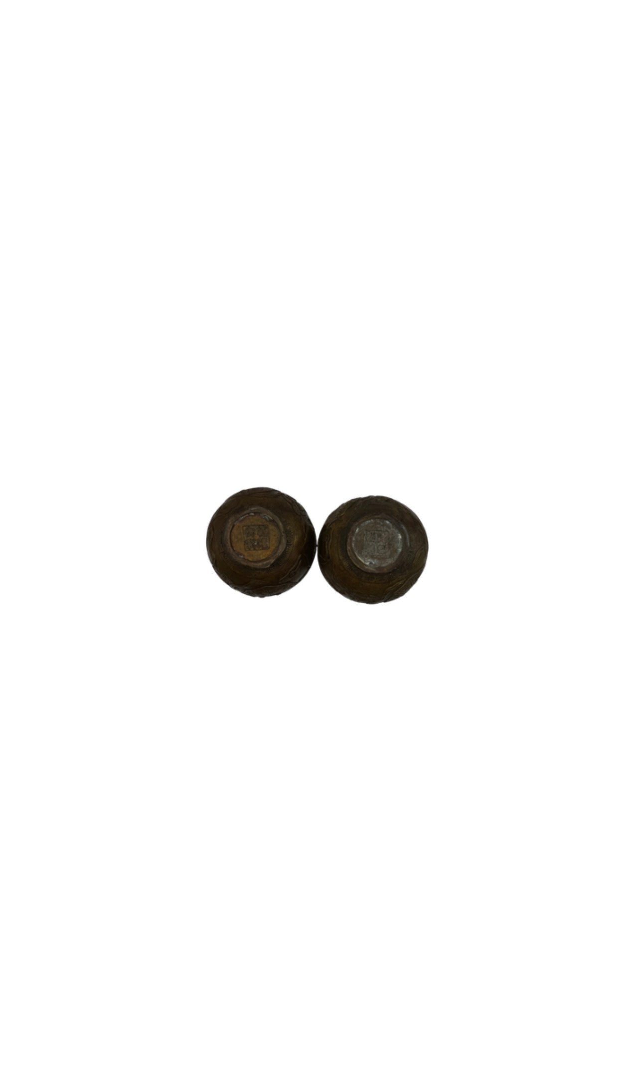 Underside of vintage brass double-gourd vases showing recessed bases and maker's marks