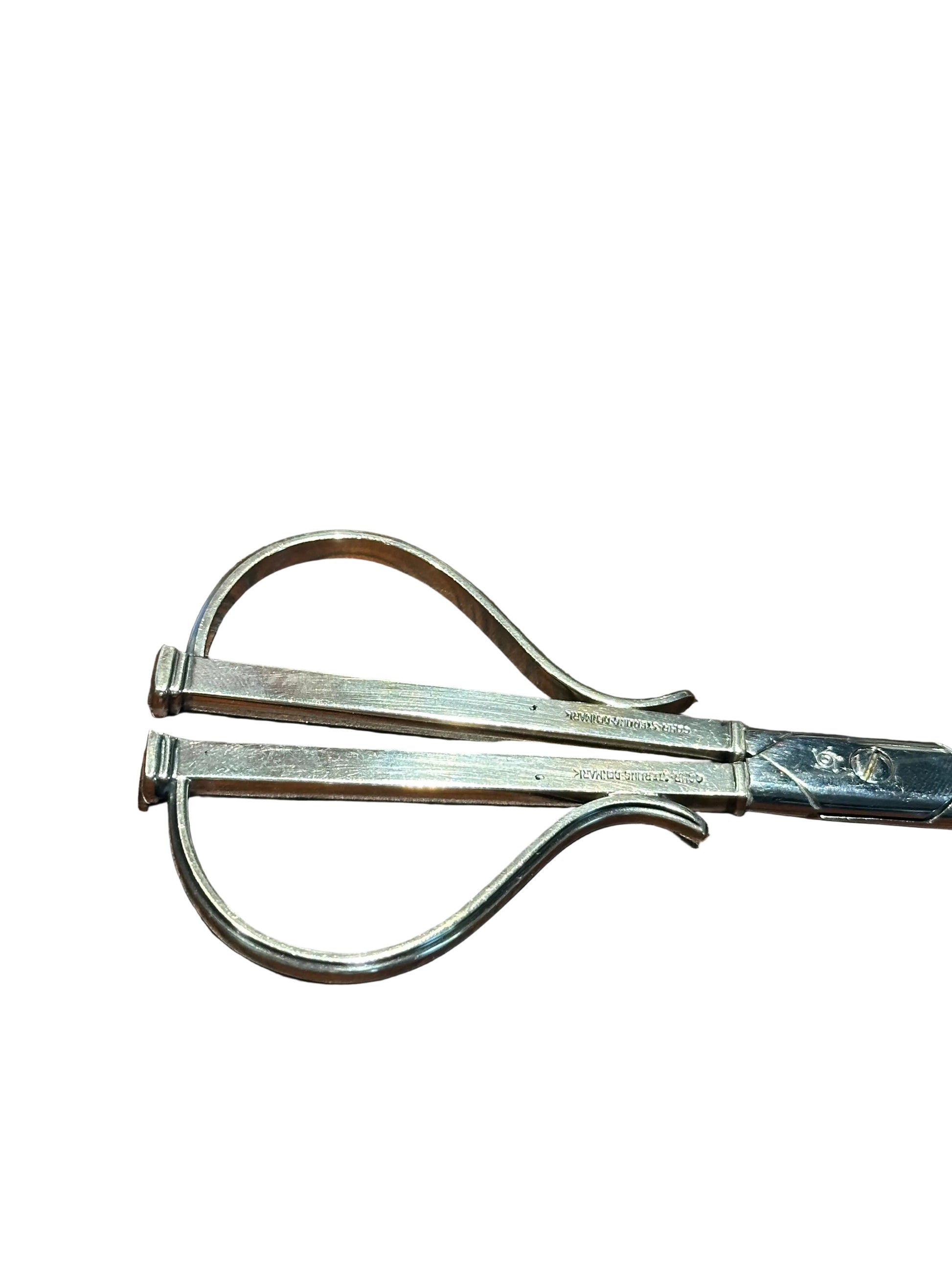 Detail of grape shears' two looped wire handles and engraved Cohr Denmark hallmarks