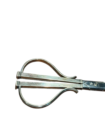 Detail of grape shears' two looped wire handles and engraved Cohr Denmark hallmarks