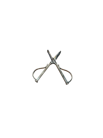 Sterling silver grape shears fully open in an X shape showing pointed cutting blades