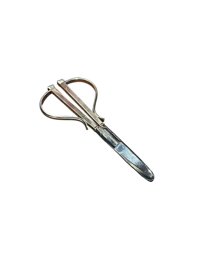 Cohr sterling grape shears resting at an angle, looped handles open and blades crossed