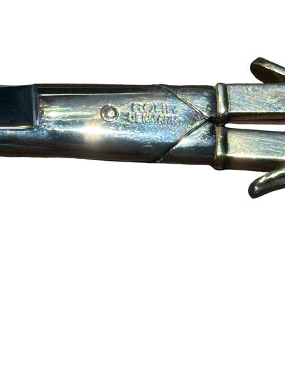 Close-up of 'Cohr Denmark' maker's mark stamped on the sterling silver grape shears handle