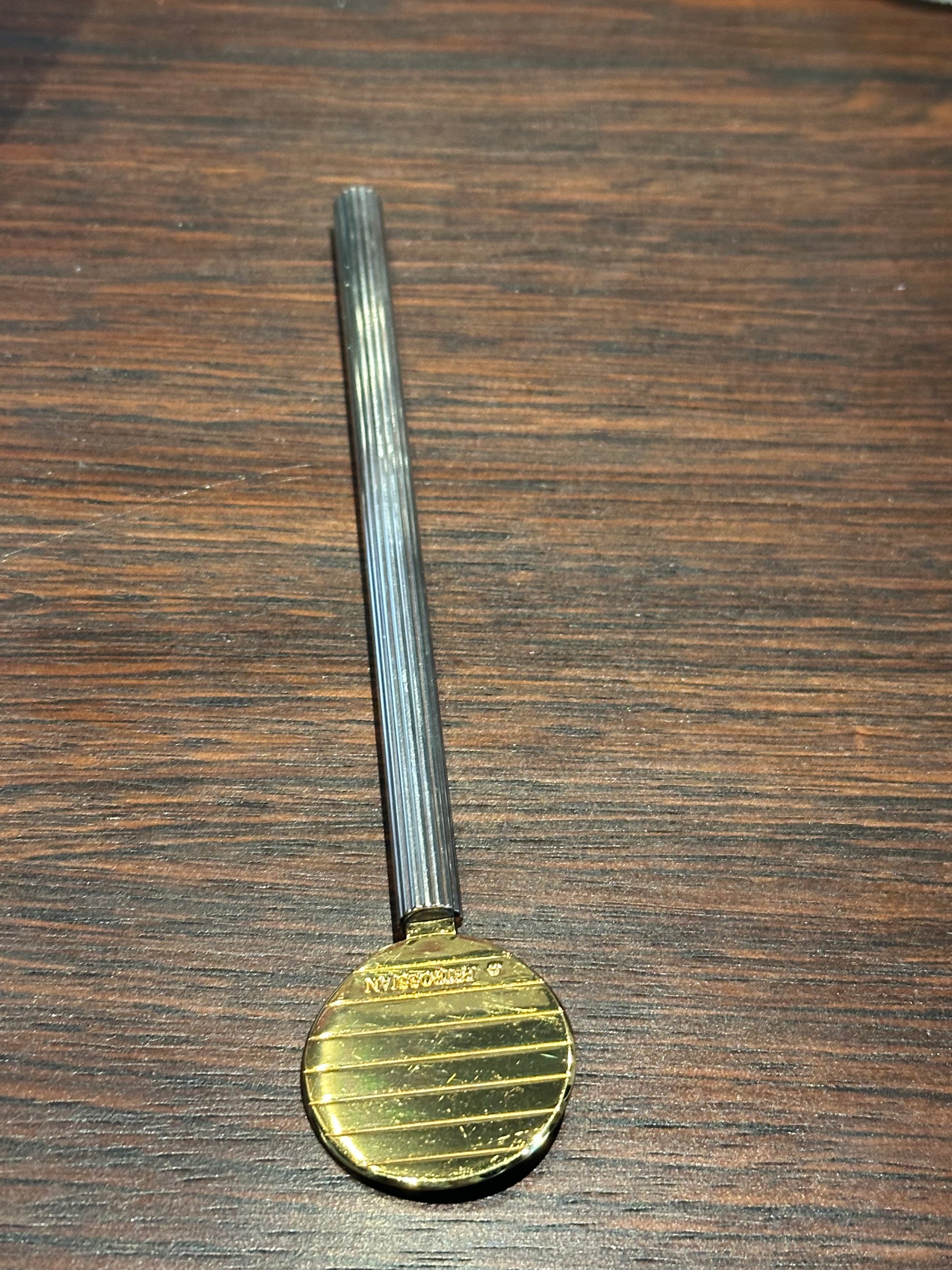 Petrossian paddle spoon on wood, gilt paddle engraved with the Petrossian name