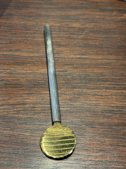 Petrossian paddle spoon on wood, gilt paddle engraved with the Petrossian name